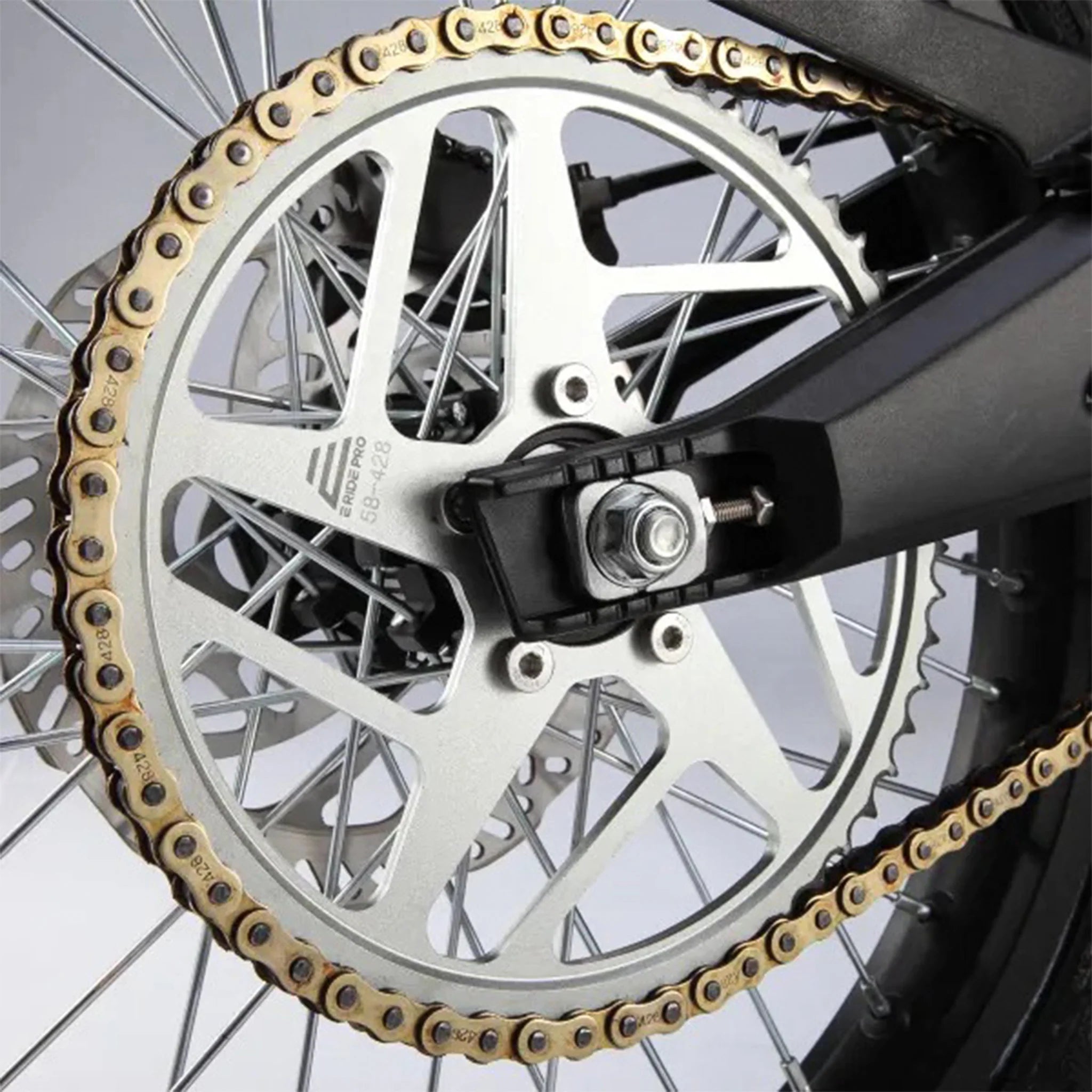 Close-up of a motorcycle chain and sprocket with a blurred background