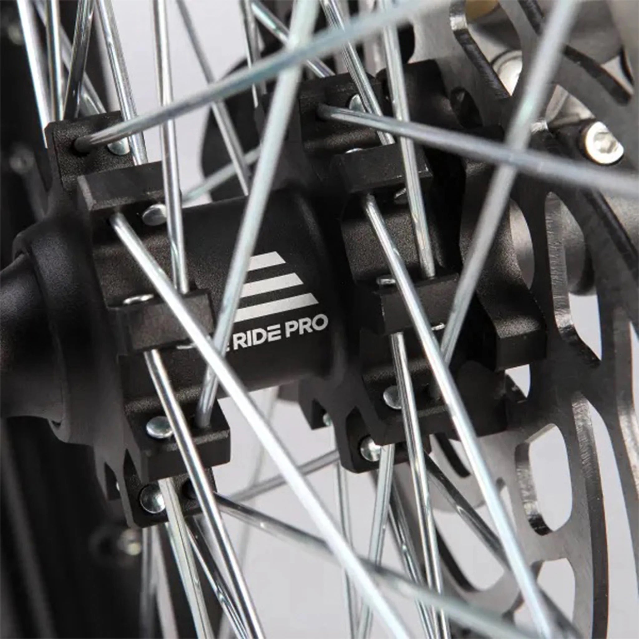 Close-up of a bike wheel with 'RIDE PRO' branding on a black background