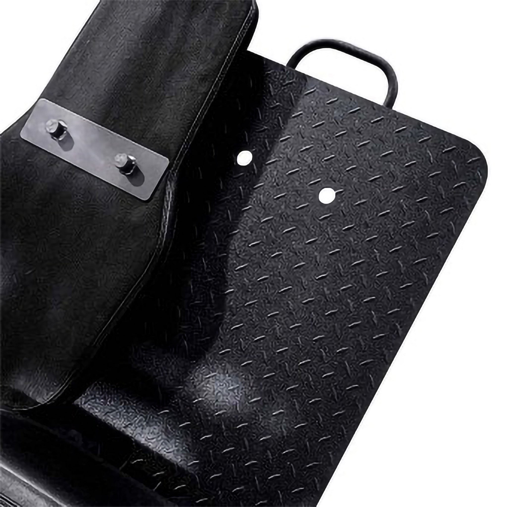 Detailed view of textured footplate and contoured back pad on a leg press machine, designed for stability and user comfort