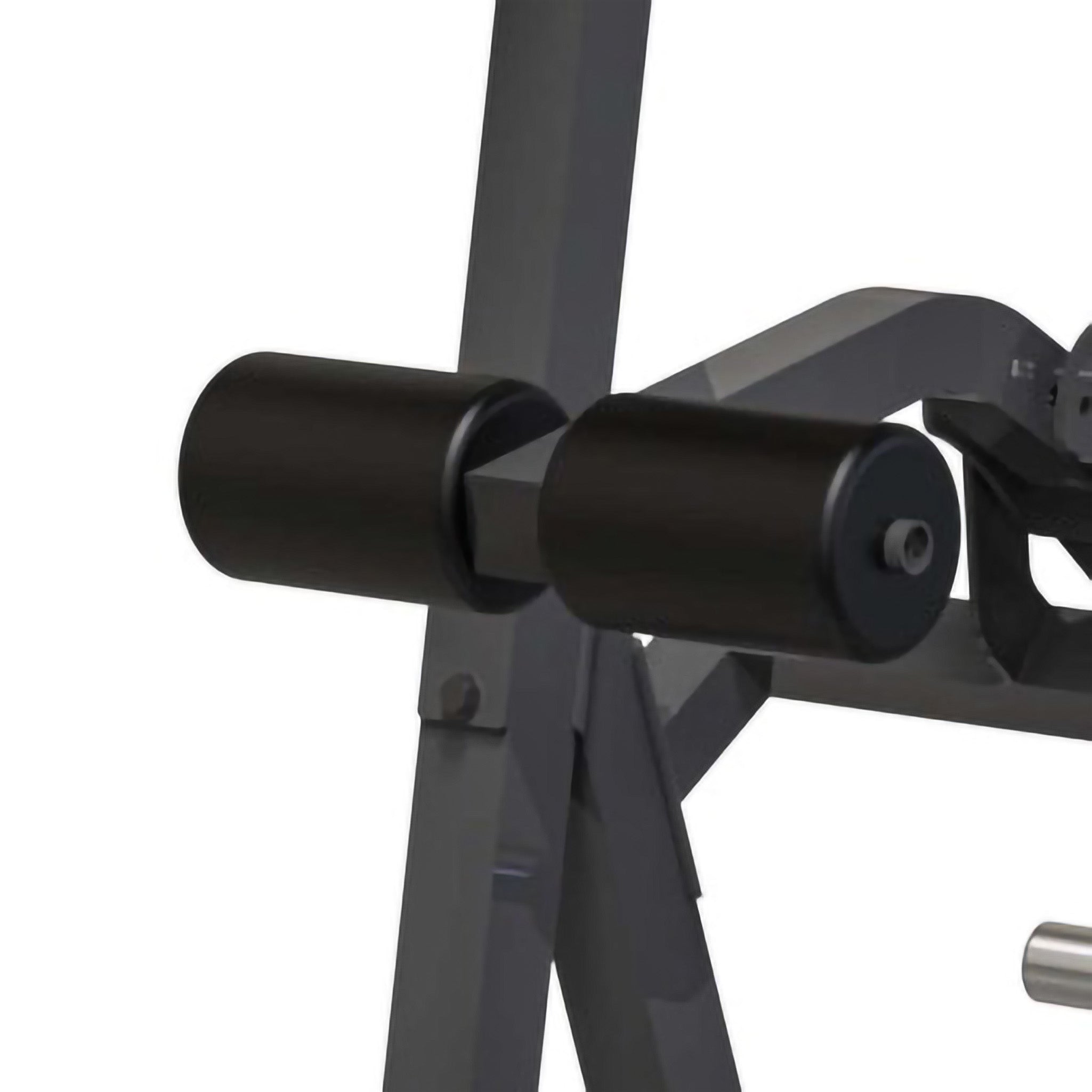 Close-up of foam roller pads on a power tower workout station for secure leg support during exercises