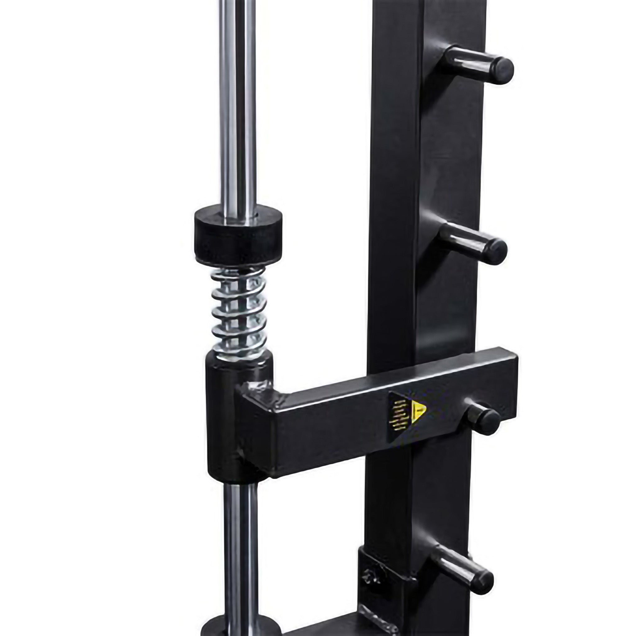Close-up of the Smith machine safety stop mechanism with heavy-duty spring for controlled barbell motion and user protection