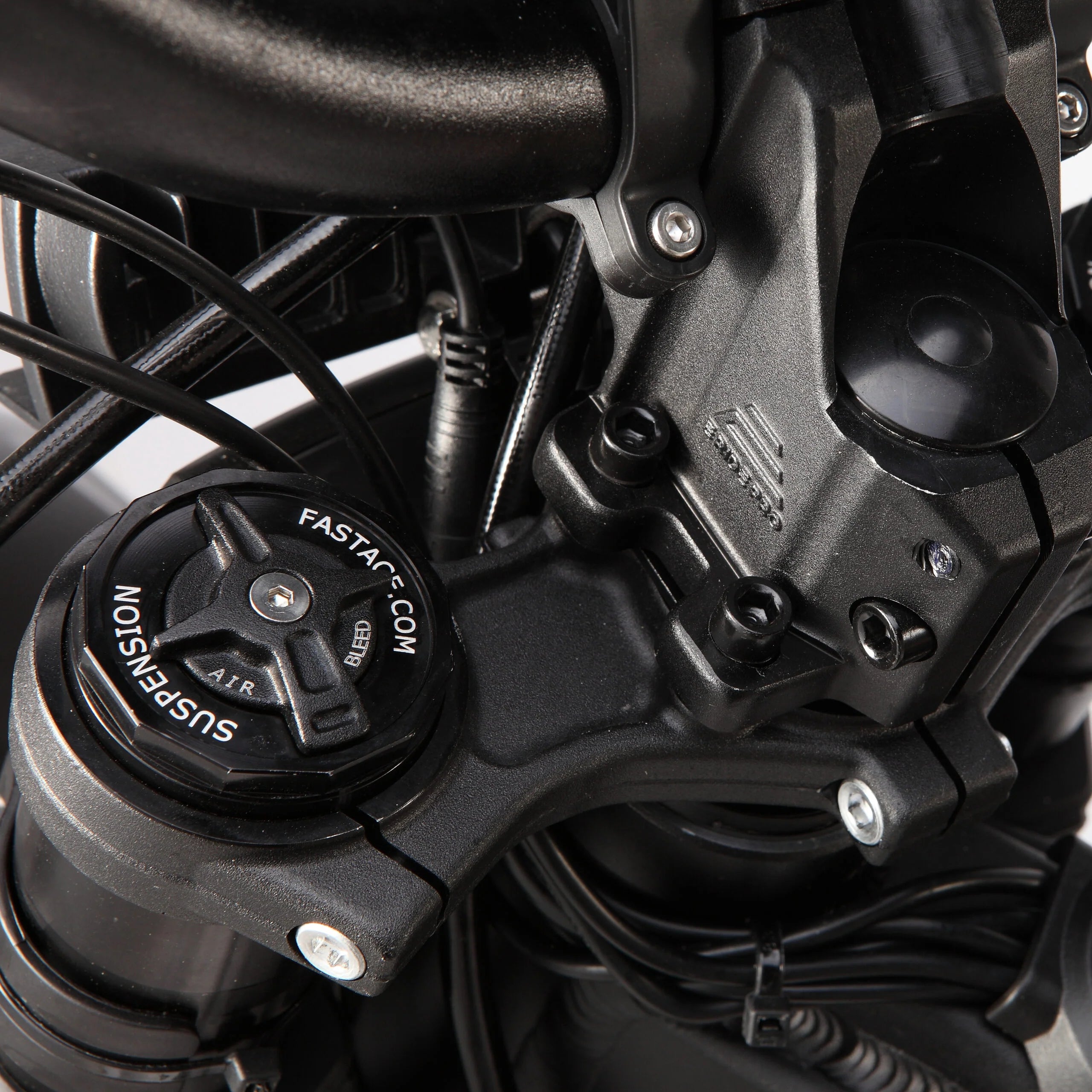Close-up of a motorcycle suspension system with visible branding.