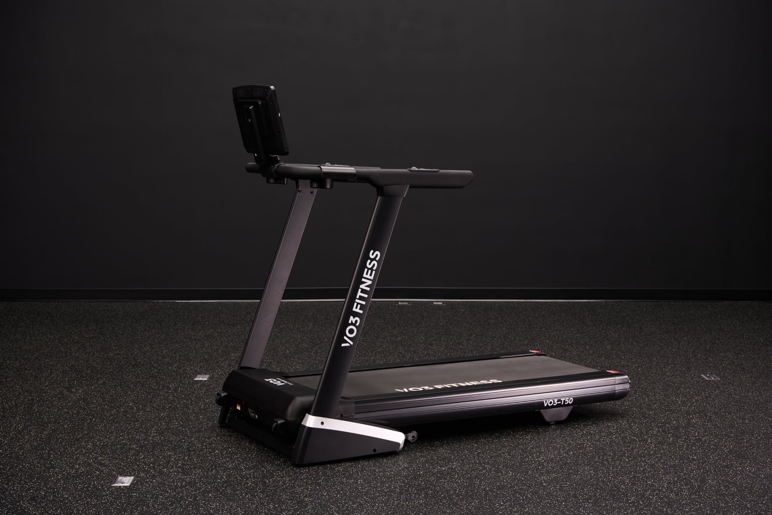 VO3 Fitness folding treadmill in a dark studio
