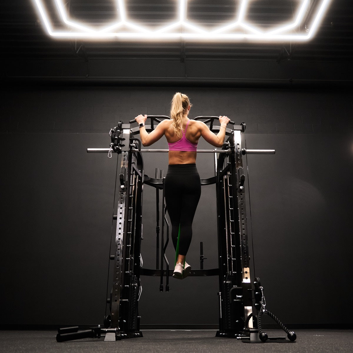 Woman doing pull-ups on a VO3 functional trainer